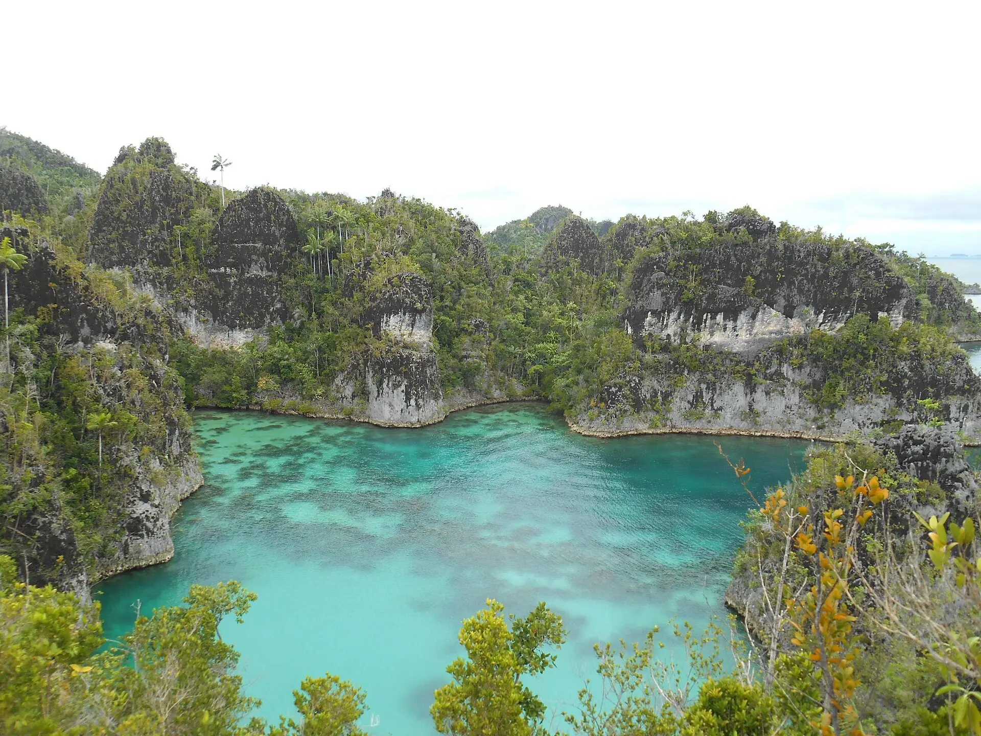 Telaga Bintang lagoon ringed by jagged limestone karst, Raja Ampat